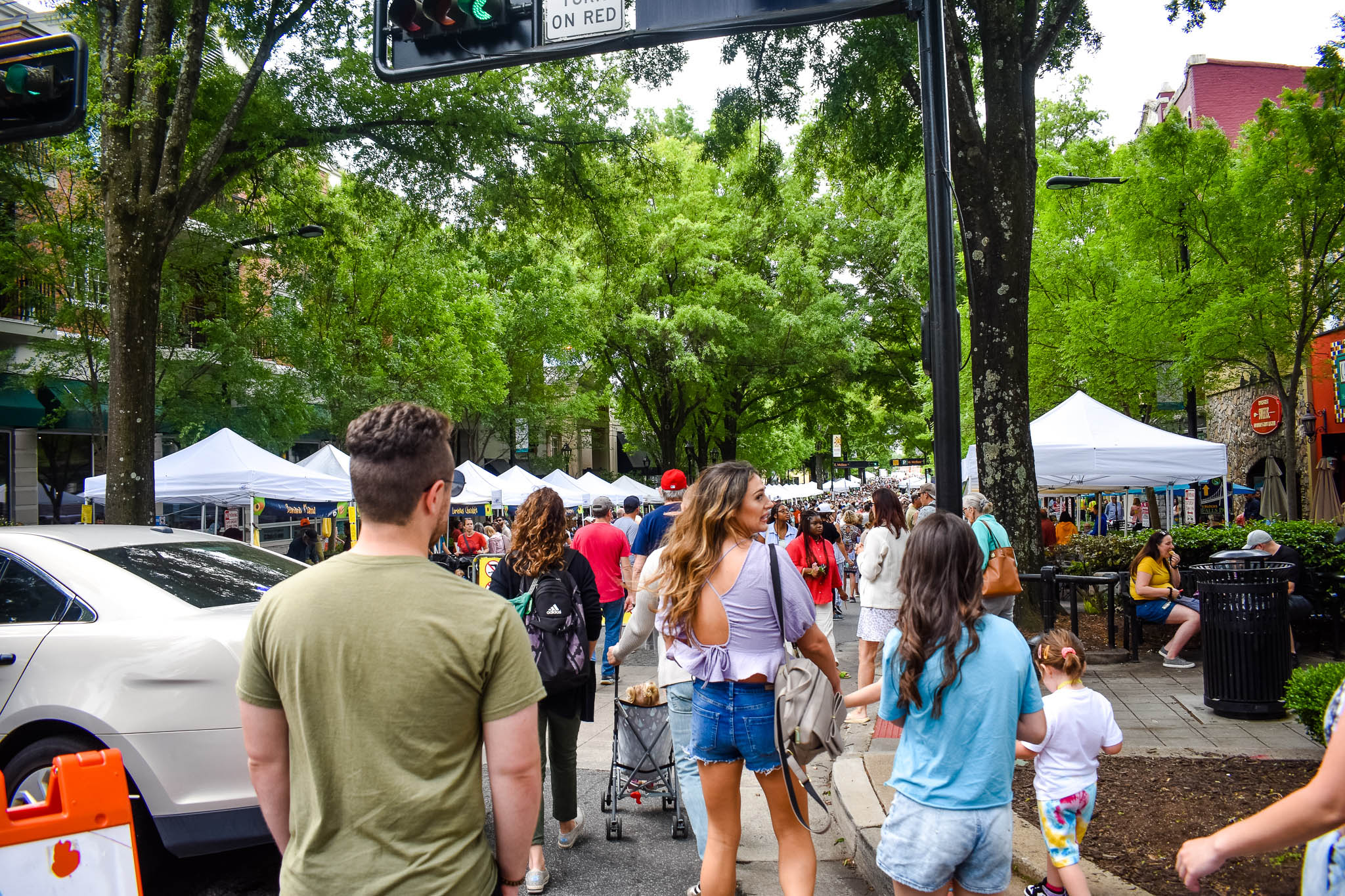 Locals and visitors enjoying the TD Saturday Market in downtown Greenville, SC. Taken by Allspice Photography, LLC.
