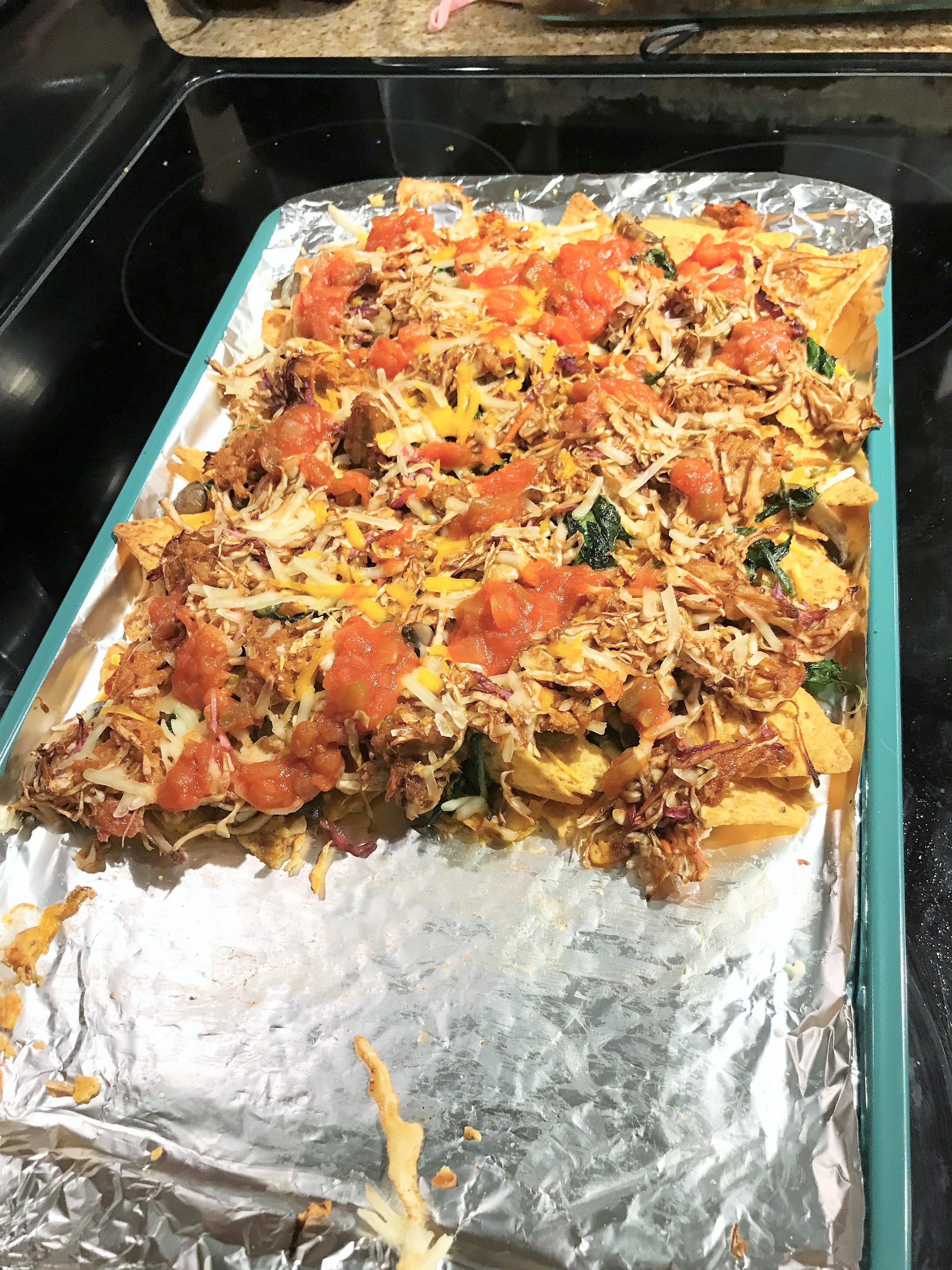 Last round of toppings on the best nachos, taken by Allspice Photography, LLC.