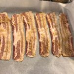 Laying out the bacon on parchment and a sheet tray, taken by Allspice Photography, LLC.