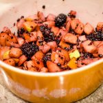 Cutting up fruit for the pie, taken by Allspice Photography, LLC.