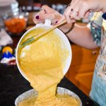 Pouring the gluten-free cornbread batter into baking dish, taken by Allspice Photography, LLC.