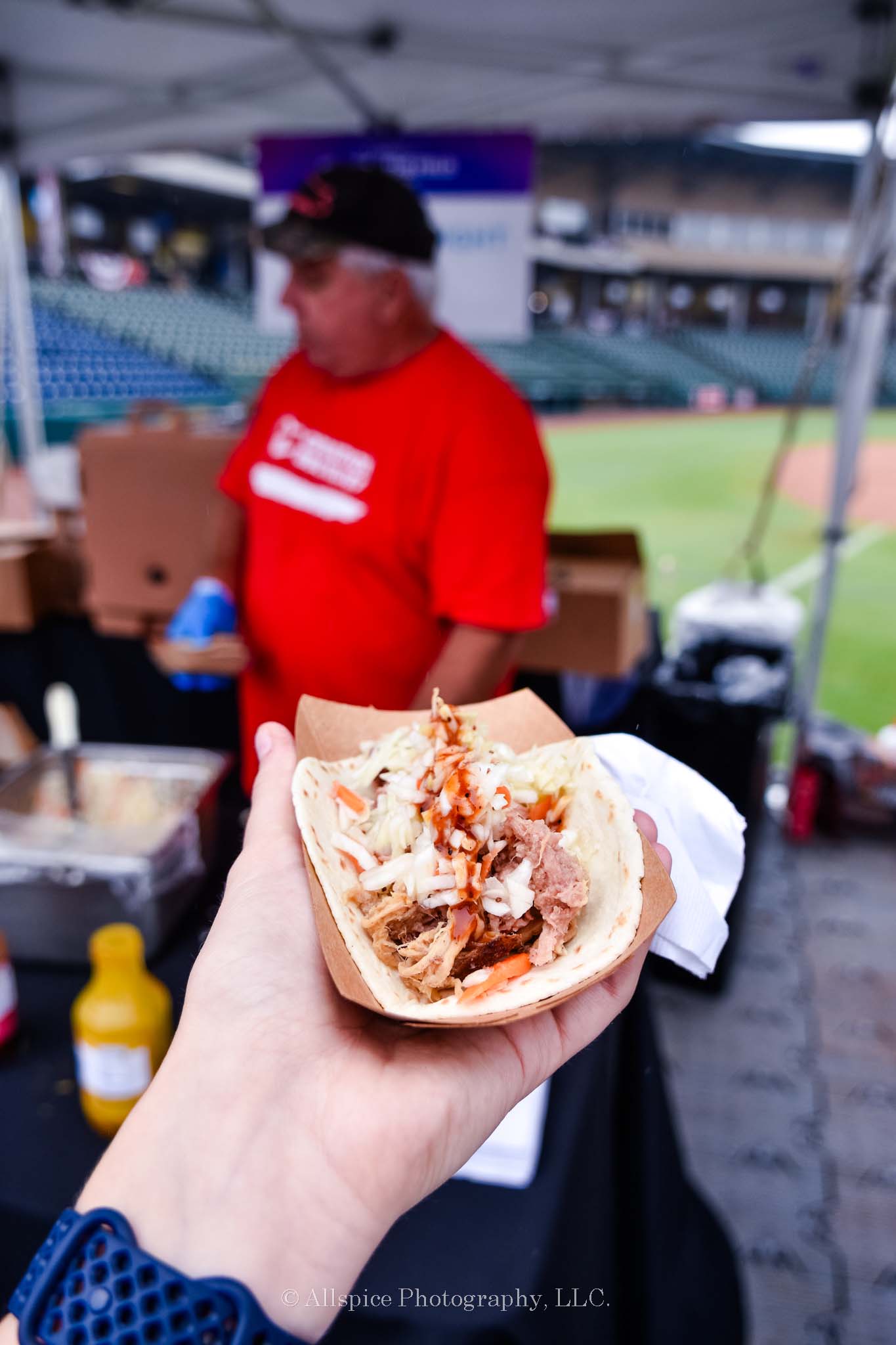 Pulled pork taco with coleslaw and Sweet Red Sauce from Nard's BBQ at Feast by the Field, taken by Allspice Photography, LLC.