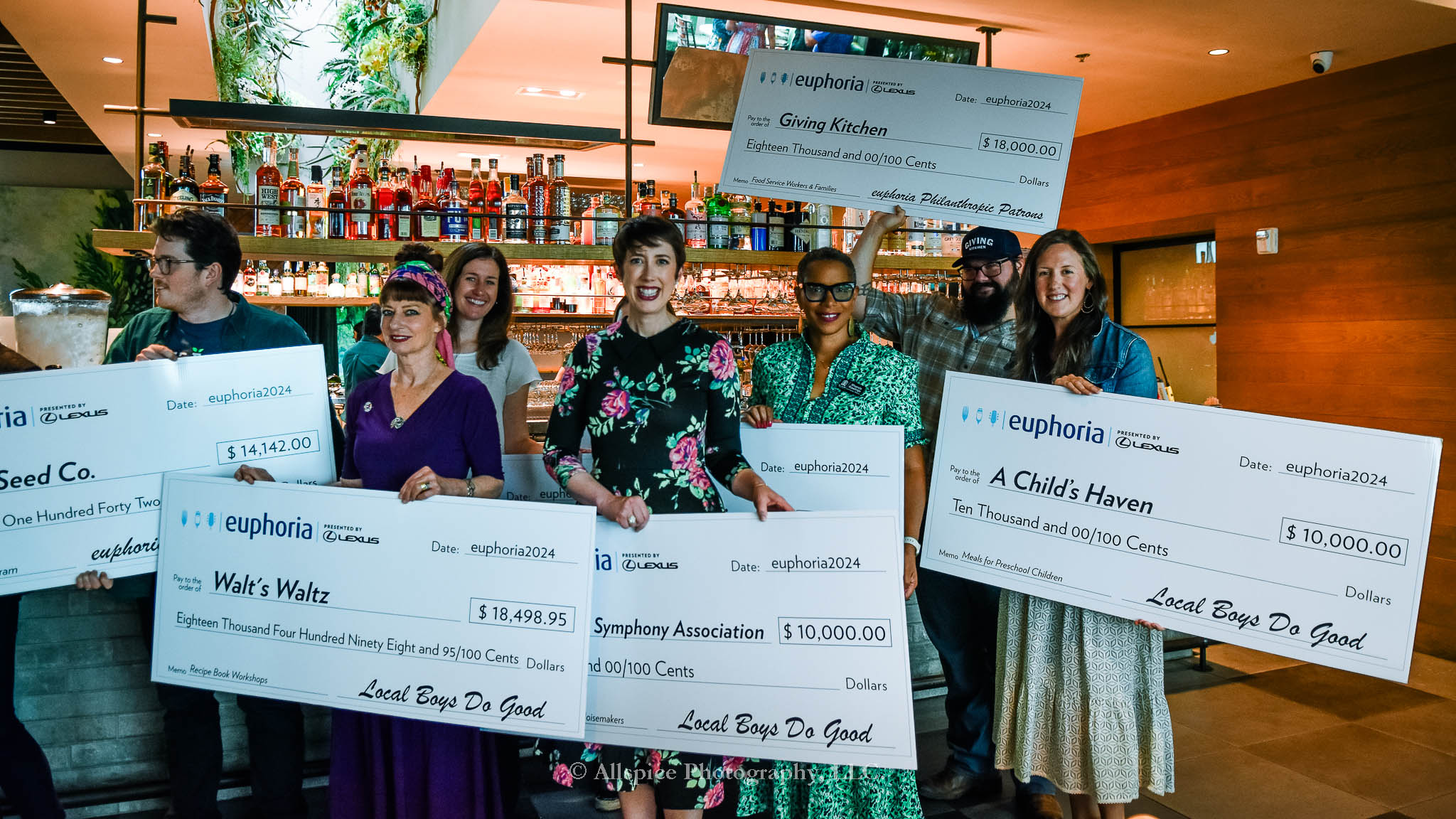 Folks receiving big donation checks at the Euphoria Greenville Schedule Release Party at Juniper Greenville. Taken by Allspice Photography, LLC.