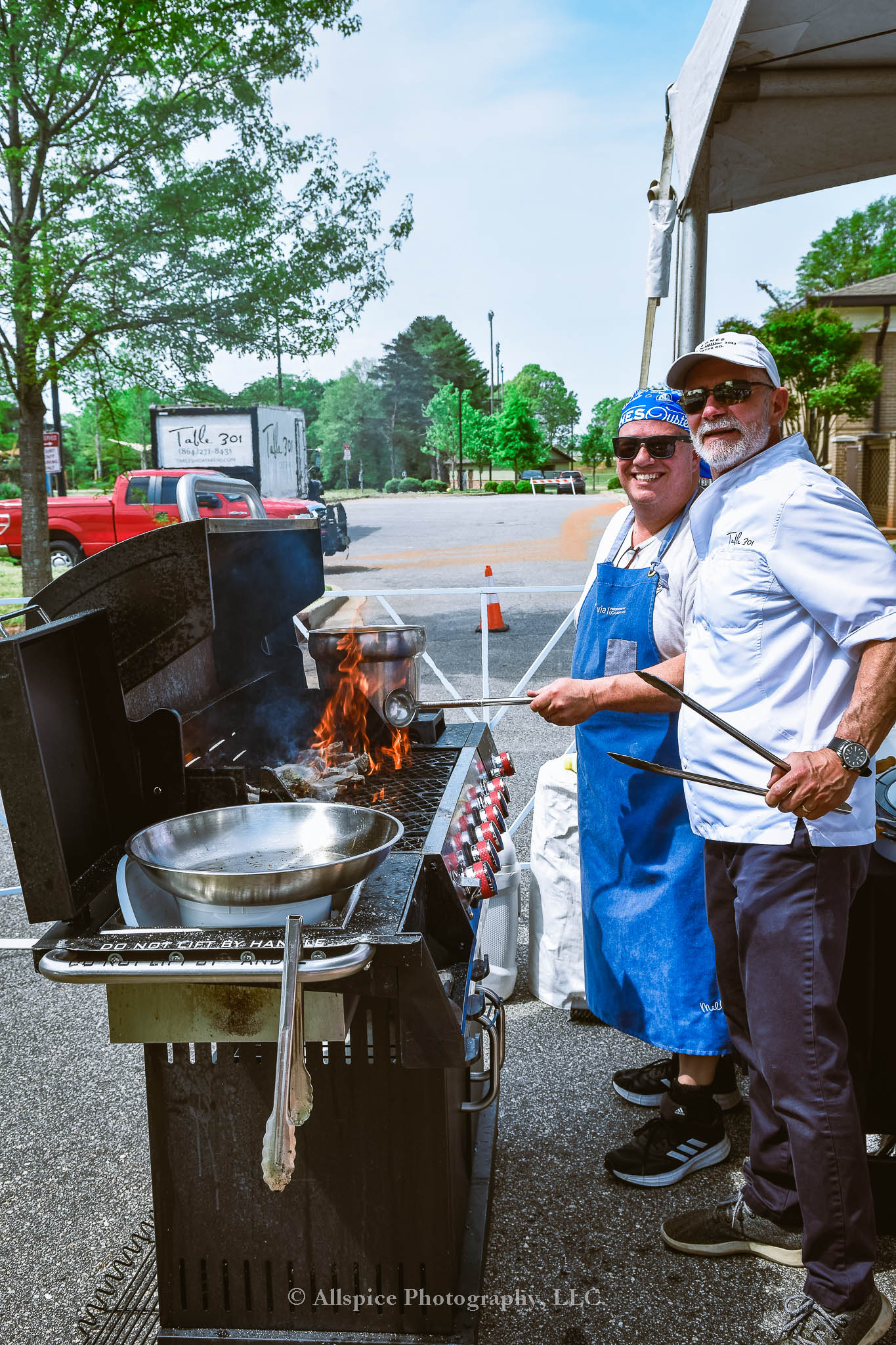 Chefs from Jones Oyster Co. grilling up oysters in the VIP section of Southern Roots Reunion 2024. Taken by Allspice Photography, LLC.