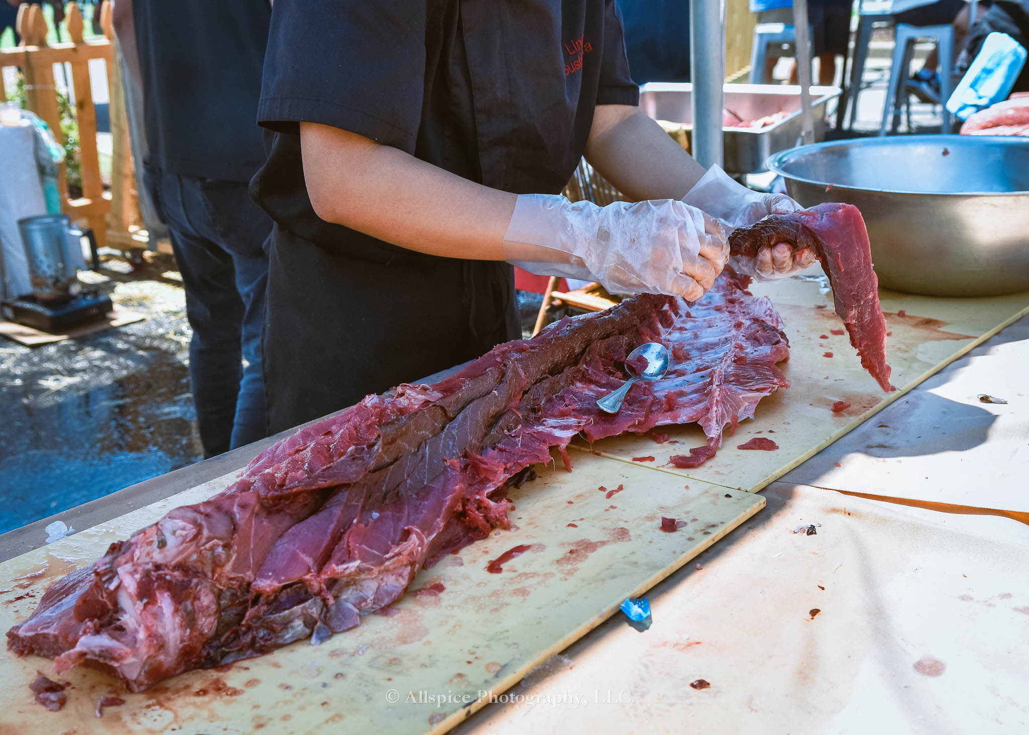 Watching the Live Tuna Cutting from Sushi Yama Travelers Rest at Souther Roots Reunion. Taken by Allspice Photography, LLC.