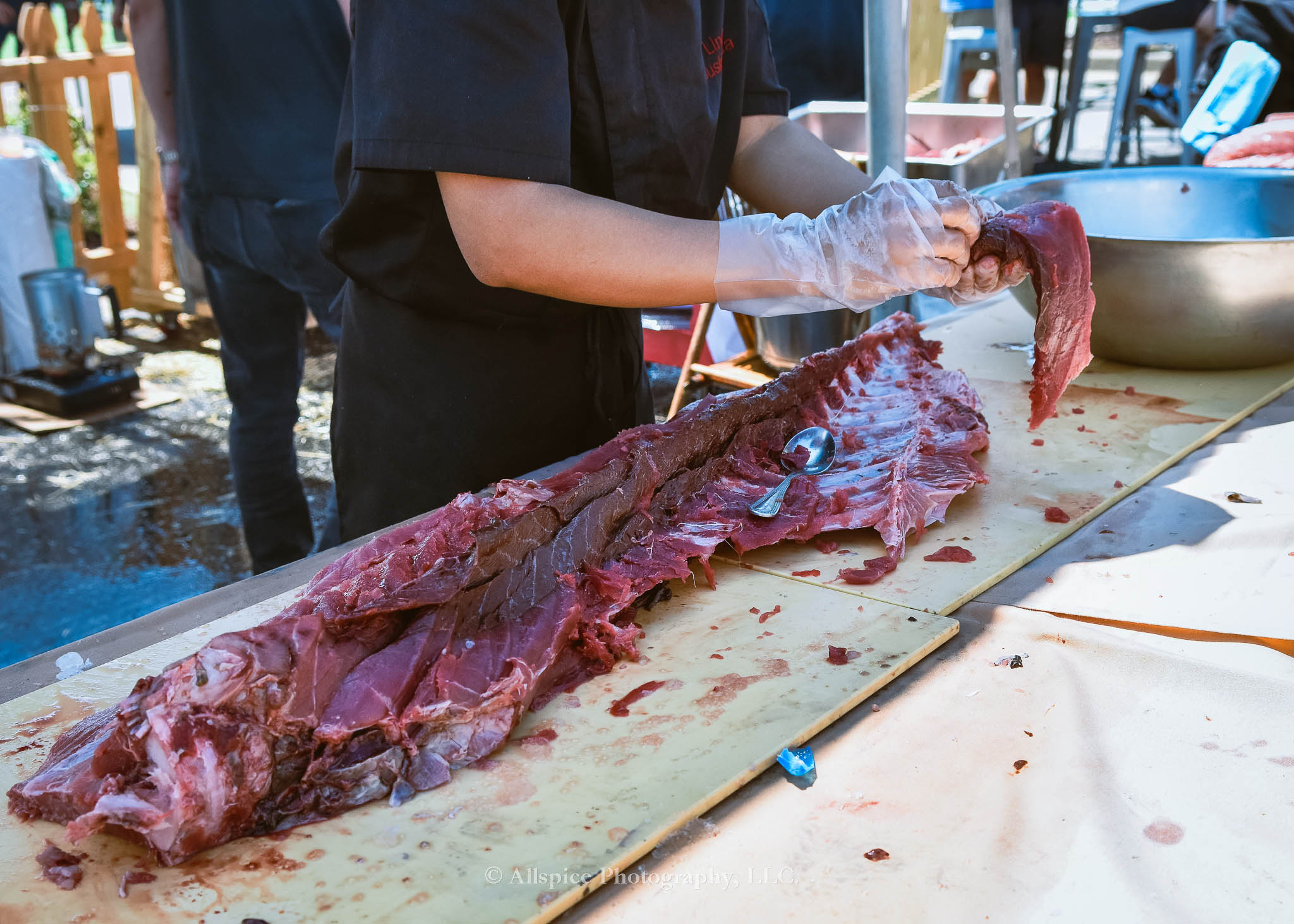 Watching the Live Tuna Cutting from Sushi Yama Travelers Rest at Souther Roots Reunion. Taken by Allspice Photography, LLC.